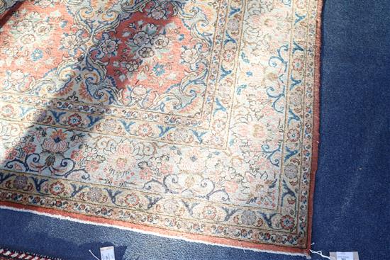 A Persian brick red ground carpet, 331 x 231cm